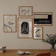 a wooden table topped with a vase filled with flowers next to pictures on the wall