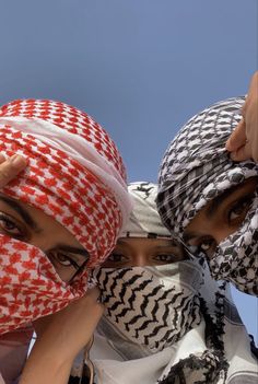 three women with headscarves covering their faces