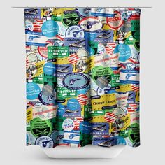 a colorful shower curtain with various stickers on it