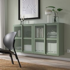 a green cabinet with glass doors in a room