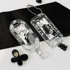 a couple of cell phones sitting next to each other on a black mat with beads