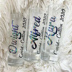 three personalized glass tumblers sitting on top of a white blanket