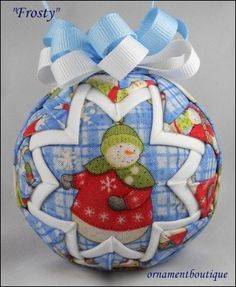 an ornament with a snowman on it and a blue ribbon around the top