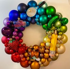 a wreath made out of christmas balls and ornaments