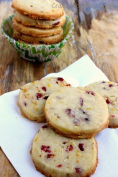 several cookies are stacked on top of each other in front of a bowl of cookies