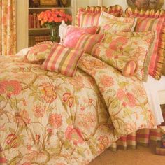 a bedroom with a bed covered in a floral comforter and matching pillow shampoos