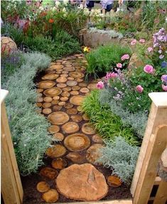 a pathway made out of logs in a garden