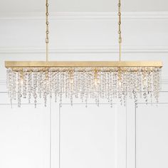 a chandelier hanging from the ceiling in a room with white walls and doors