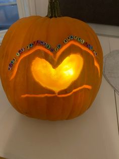 a pumpkin carved to look like a heart