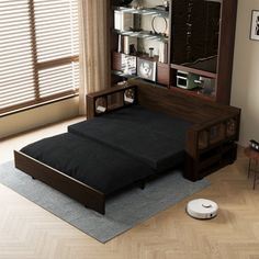 a bed sitting on top of a wooden floor next to a window