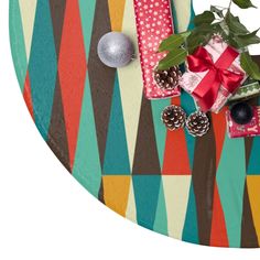 presents are wrapped in colorful wrapping paper and tied with red ribbon, pine cones, and christmas balls