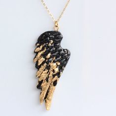 This Polymer Clay Wing Pendant is edgy and eye catching and is perfect for layering. It's hand moulded and shaped, finished with metallic foil and 3 coats of quality varnish to give it a nice glossy finish that make the wing pattern stand out. The Wind Pendant is suspended from a gold filled 18 inch 46 cm flat cable chain.I am a trained designer and make all of my creations out of my studio in Melbourne. I also run a very active lifestyle and fashion blog. So if you need any fashion advice for e Black And Gold Necklace, Necklace Gold Chain, Gold Filled Necklace, Black Wings, Rose Gold Chain, Clay Design, Metallic Foil, Chain Gold, Necklace Black