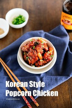 korean style popcorn chicken with chopsticks on a blue napkin next to two bowls