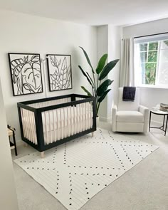 a baby crib in a white and black nursery