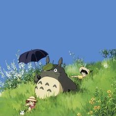 totoro and other characters in the grass with an umbrella over their heads, on a sunny day