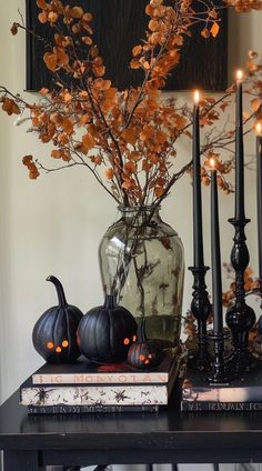 a table with candles and pumpkins on it