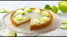 a cheesecake topped with lime slices on a plate