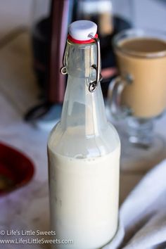 a glass bottle filled with milk sitting on top of a table