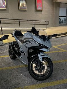 a silver motorcycle parked in front of a building