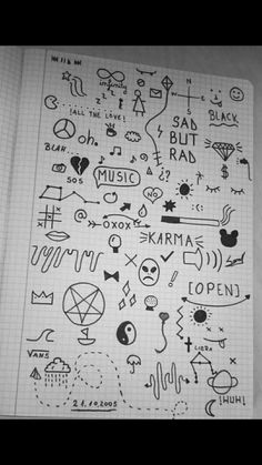 a notebook with various doodles and symbols on the pages, all in black ink