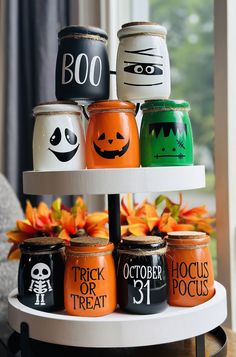 halloween jars are stacked on a three tiered tray