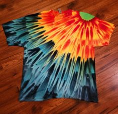 a colorful tie - dyed t - shirt is laying on the floor