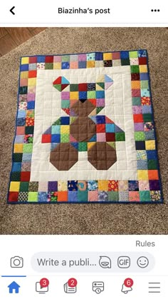 a person standing next to a quilted teddy bear on top of a carpet covered floor