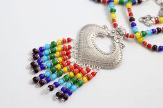 If you love beaded jewelry with a splash of color, you will find this Rainbow Row necklace to your liking. Silver pendant with a variety of colored African white heart beads as well as silver spacers. An adjustable chain with large lobster claw clasp. The perfect addition to her jewelry collection, this versatile necklace is sure to become an everyday staple. Rainbow Row, Murano Glass Beads, Lobster Claws, Heart Beads, White Heart, Artisan Jewelry, Lobster Claw, Semiprecious Stones, Precious Stones