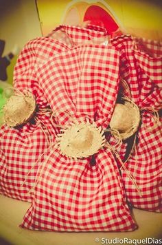 red and white gingham bags sitting on top of a table