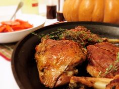 some meat and vegetables in a pan on a table