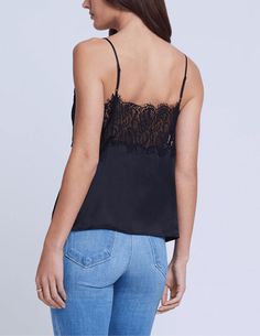 L'Agence Priya Lace Cami in black. Sleeveless. Adjustable spaghetti straps. Lingerie-inspired cami. Black silk charmeuse. Deep V-neckline. Thick lace trim detail. Eyelash-trimmed scallop-edge detail. Semi-fitted design. Unlined. 100% Silk. About 18.75" From Shoulder to Hem. Model Details: Height: 5'10" | Bust: 32" | Waist: 24'' | Hips: 34.5'' | Wearing Size XS. Imported. Great Neck New York, Scallop Edge, Silk Charmeuse, Lace Cami, Trim Detail, Black Sleeveless, Black Silk, How To Be Outgoing, Lace Trim