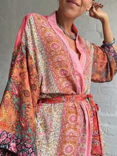 "This is one of a kind patchwork, upcycled silky robe Made free size with wrap tie closing and wide kimono sleeves  Easy and fun to wear around the house or outside as a urban boho style,  flowy kardigan with jeans and tshirt  It is very comfy and feels soft and light  the material is colourful indian saree silk made into this unique stylish over all MEAESURE free size length 55\" MATERIAL *polyester and silk * no lining more avaialable at  https://www.etsy.com/shop/AltheaStores? CARE INSTRUCTIO Multicolor Wrap Kimono For Festivals, Hippie Multicolor Open Front Kimono, Hippie Style Multicolor Wrap Kimono, Colorful Summer Kimono With Kimono Sleeves, Patchwork Kimono For Summer Festivals, Pink Wrap Kimono In Bohemian Style, Pink Hippie Kimono For Summer, Hippie Patchwork Kimono For Spring, Spring Festival Kimono With Patchwork