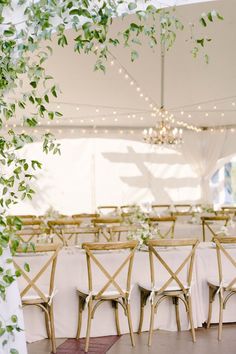 Take a peek into this elegant, garden wedding at Lairmont Manor with greenery climbing up the reception tent, all white centerpieces, and a soft yet modern feel. Flowers: Botanique Photo: Kerry Jeanne Photography