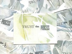 there is a piece of paper that says trust the process and it's surrounded by other words