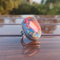 Pink Spiny Oyster Turquoise Ring  _._._._._._._._._._._._._._._._._._ Gemstone: Natural Pink Spiny Oyster Turquoise Gemstone Size: 20x30mm Gemstone Shape: Oval _._._._._._._._._._._._._._._._._._ Metal Type: 925 sterling silver  Weight : 12-15 Gram (Approx) Made In: Jaipur, India _._._._._._._._._._._._._._._._._._ FEEDBACK:-) If you like the item and satisfied with our service, once you purchased it, please give us a five stars review. Others should also know that we are giving are best. A positive feedback represents our service, product quality and dedication towards  customer's satisfaction.  Or If you are not satisfied with your purchased items then contact with us first before leaving negative or neutral feedback or opening disputes. We believe in solving the issue. Our future busine Handmade Round Crystal Ring, Bohemian Cabochon Rings As A Gift, Bohemian Cabochon Ring For Gift, Bohemian Cabochon Rings As Gift, Spiritual Opal Ring Gift, Spiritual Turquoise Cabochon Ring As Gift, Bohemian Opal Ring For Gifts, Crystal Ring With Natural Stones, Multicolor Opal Gemstone Ring Gift