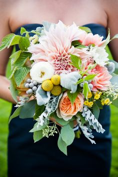 a woman holding a bouquet of flowers in her hands