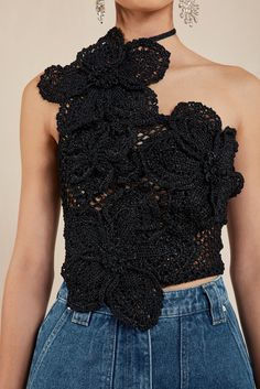 a woman wearing a black top with flowers on it