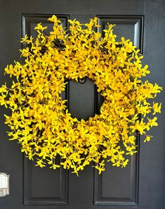 a yellow wreath is hanging on the front door