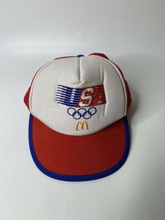 Vintage McDonald’s 1984 USA Olympic Snap Back Embroidered Truckers Cap Hat. Retro Trucker Hat With Embroidered Logo, Retro Sports Baseball Cap, Vintage White Trucker Hat With Embroidered Logo, Retro Snapback Trucker Hat For Sports, Retro 5-panel Baseball Cap For Sports, Retro Visor Baseball Cap For Sports Events, Retro Snapback Visor Hat For Sports Events, Retro Trucker Hat For Sports Events, Retro Sports Hat With Embroidered Logo