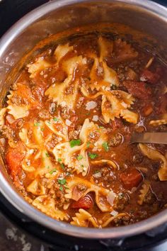 a large pot filled with pasta and meat