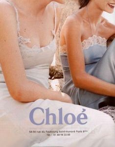 two women sitting next to each other in front of a wall with the words chloe on it