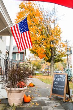 an american flag hanging from the side of a house