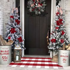 two christmas trees are decorated with red and silver tinsels on the front porch