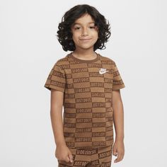 Made of soft cotton/poly jersey and featuring an allover knit pattern, this tee makes a statement. It has a tagless crewneck that creates a comfy feel and the classic cut is roomy enough for kids to move freely and Just Do It. Crew Neck Cotton Tops With Logo Pattern, Casual Cotton Tops With Logo Pattern, Brown Jacquard Knit Crew Neck Top, Brown Short Sleeve Top With All Over Print, Brown Short Sleeve Top With All-over Print, Cotton Jacquard Knit Short Sleeve Tops, Nike Casual Brown Tops, Casual Brown Nike Top, Nike Just Do It