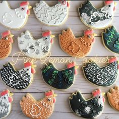 decorated cookies with hens, chickens and roosters on them are sitting on a wooden table