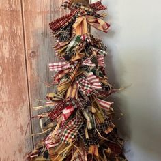 a christmas tree made out of burlocks hanging on a wall