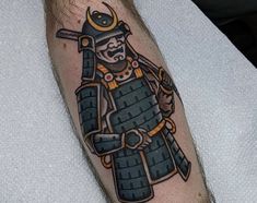 a man with a tattoo on his arm holding a baseball bat and wearing a helmet