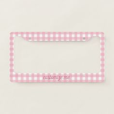 a pink license plate frame with the words customize me on it in white and pink gingham