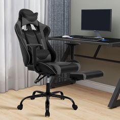 a computer chair sitting in front of a desk with a monitor and keyboard on it