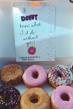 a box filled with lots of donuts next to a sign that says donut knows what we do without you